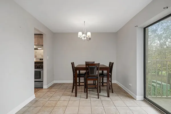 a view of a dining room with furniture and chandelier
