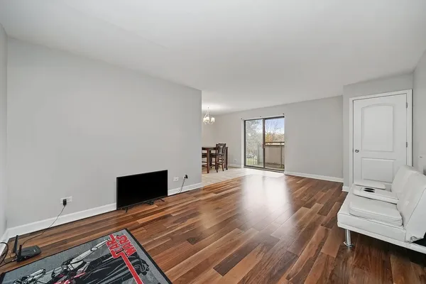 a hallway with wooden floor and cabinet