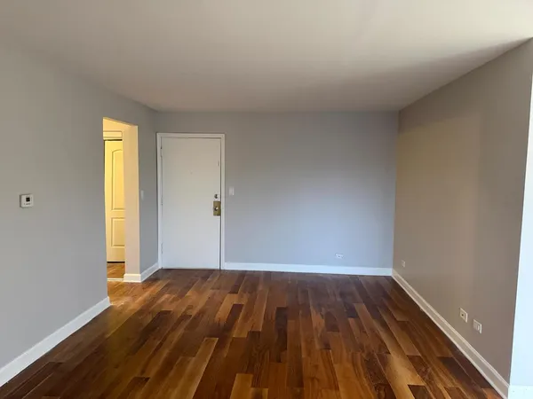 a view of room with window and wooden floor