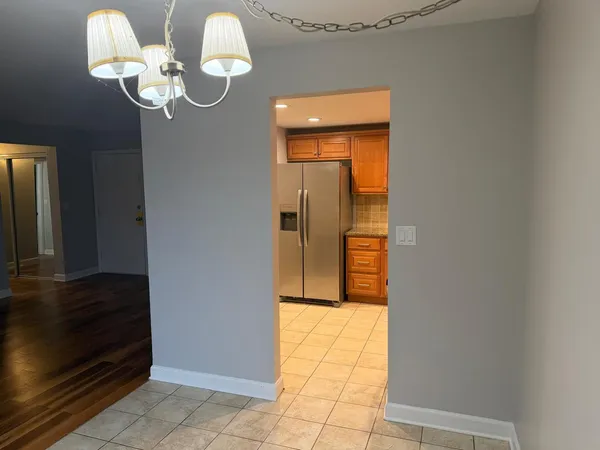 a view of a hallway to rooms and wooden floor
