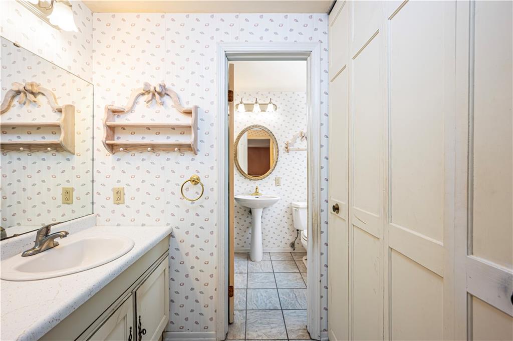 3221 Attleboro Road Greensburg, PA 15601 - Photo 23 of 38 a bathroom with a granite countertop sink a mirror and shower
