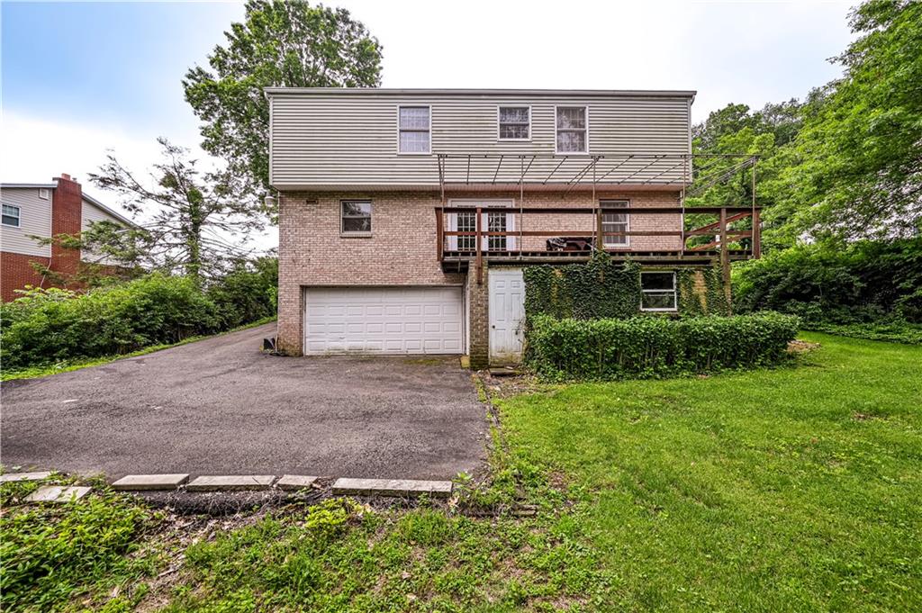3221 Attleboro Road Greensburg, PA 15601 - Photo 3 of 38 a front view of a house with a yard and garage