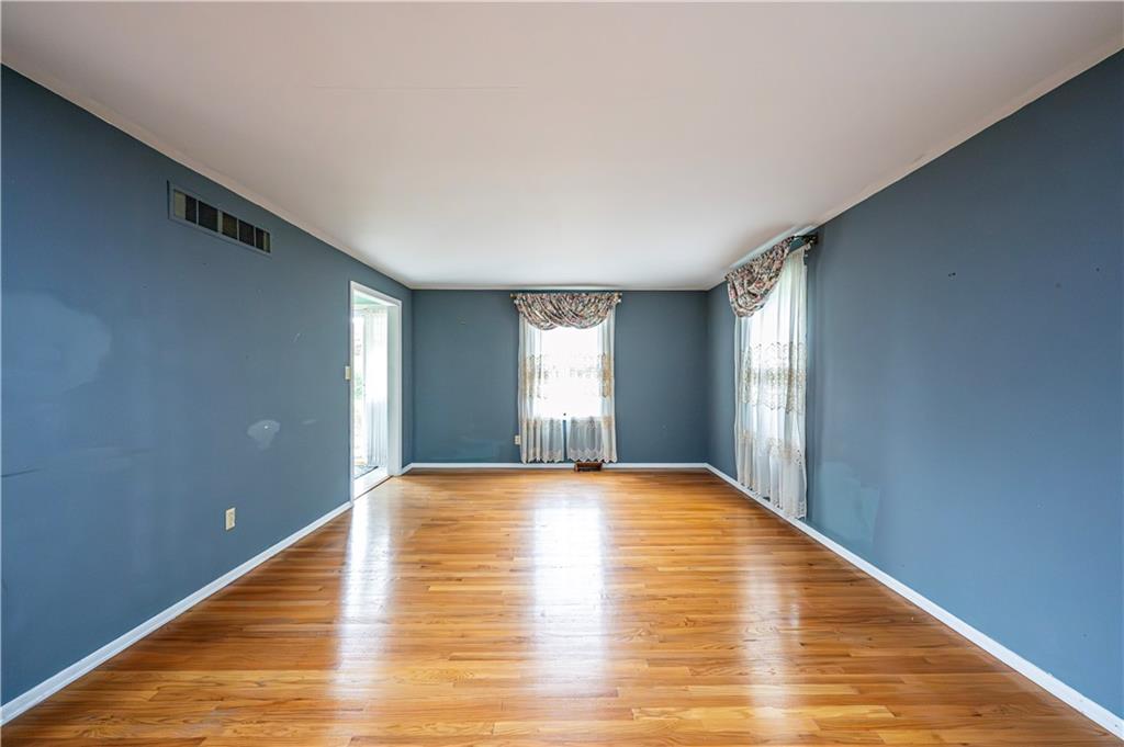 3221 Attleboro Road Greensburg, PA 15601 - Photo 8 of 38 a view of an empty room with wooden floor and a window