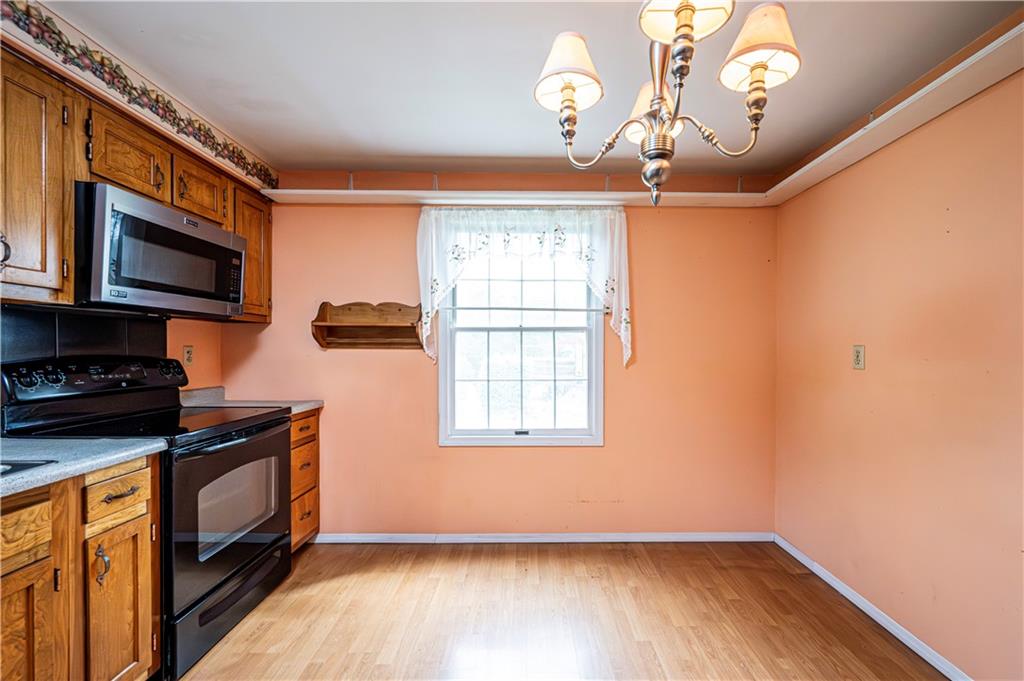 3221 Attleboro Road Greensburg, PA 15601 - Photo 10 of 38 a kitchen that has a microwave a stove and a wooden floor