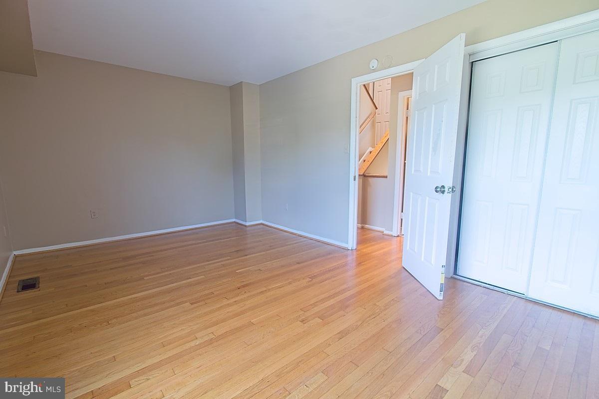 9054 Canterbury Riding, Unit 147 Laurel, MD 20723 - Photo 11 of 15 a view of empty room with wooden floor and entryway