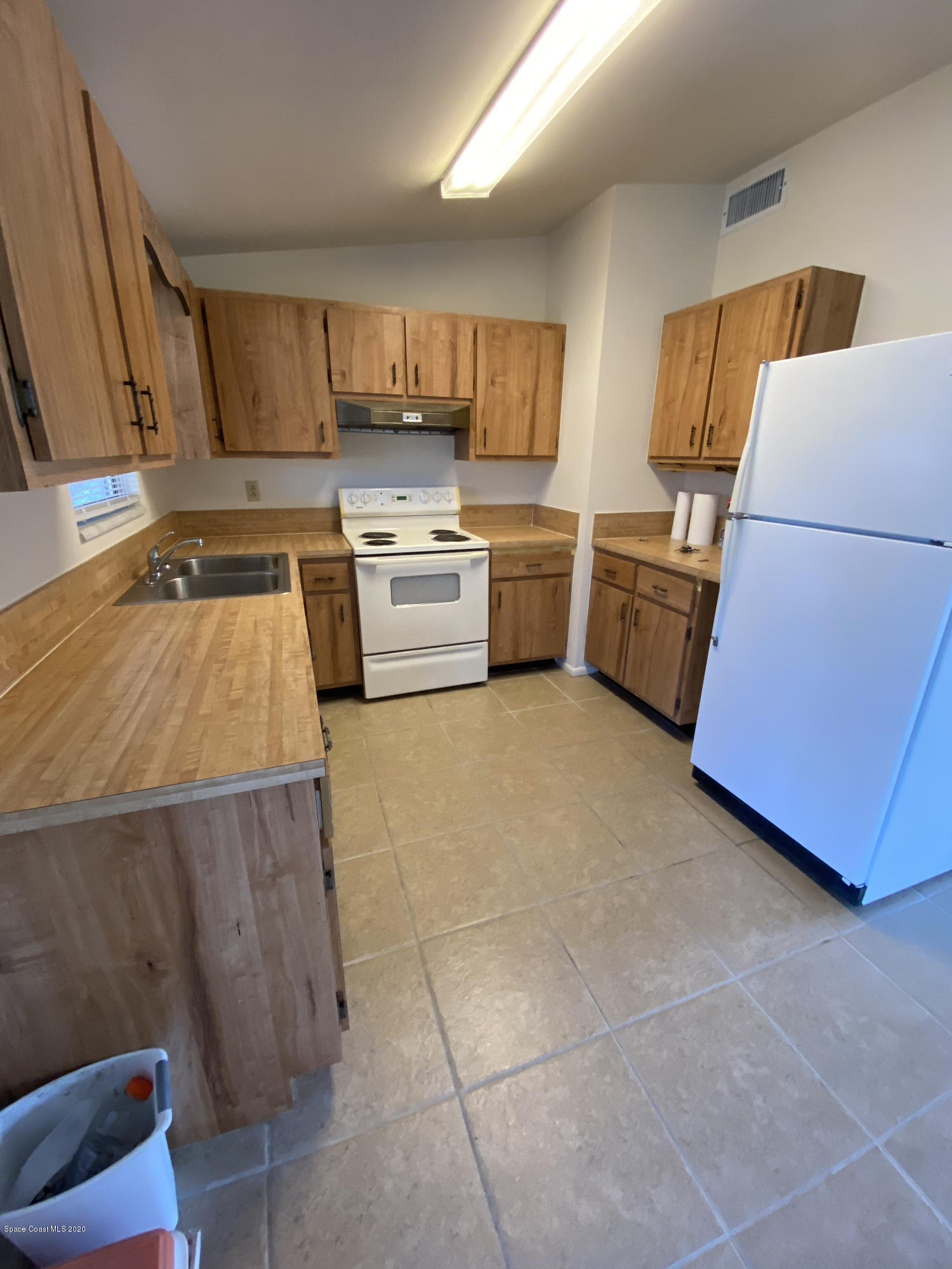 889 Bianca Drive Northeast Palm Bay, FL 32905 - Photo 4 of 12 a kitchen with a sink a counter top space cabinets and stainless steel appliances