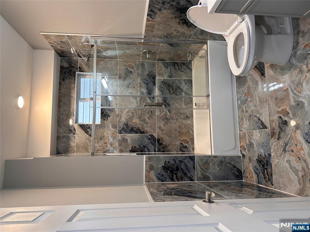 22 Knickerbocker Avenue Paterson, NJ 07503 - Photo 4 of 10 a bathroom with a toilet and a shower