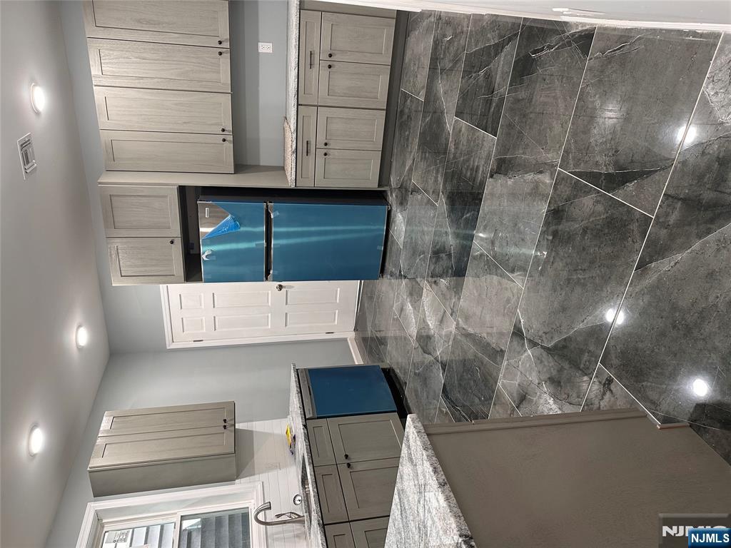 22 Knickerbocker Avenue Paterson, NJ 07503 - Photo 6 of 10 a kitchen with kitchen island granite countertop a sink a stove a refrigerator and a cabinets