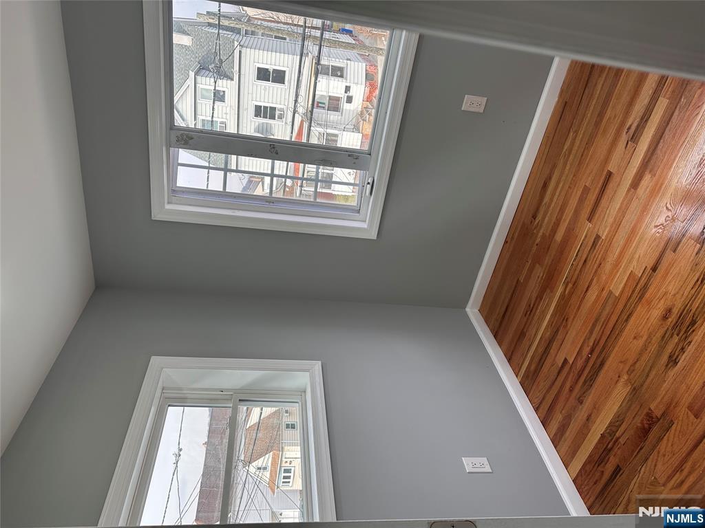 22 Knickerbocker Avenue Paterson, NJ 07503 - Photo 10 of 10 a view of empty room with wooden floor and fan