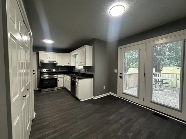 a kitchen with stainless steel appliances a refrigerator sink and cabinets