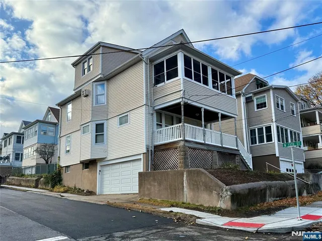 a front view of a house with a street