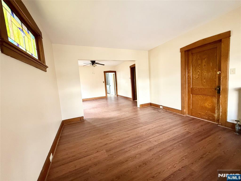 140 Westervelt Avenue, Unit 1 Hawthorne, NJ 07506 - Photo 11 of 20 a view of an empty room with wooden floor and a window