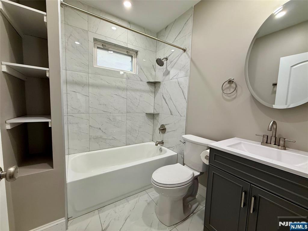 140 Westervelt Avenue, Unit 1 Hawthorne, NJ 07506 - Photo 12 of 20 a bathroom with a toilet a sink and bathtub