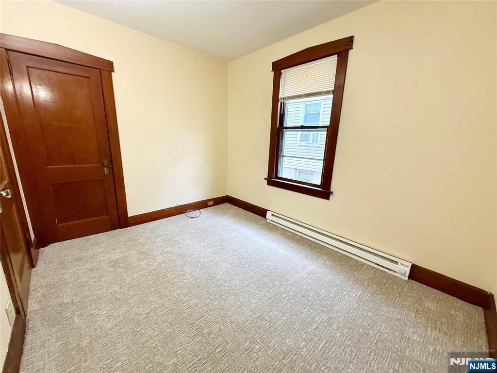 140 Westervelt Avenue, Unit 1 Hawthorne, NJ 07506 - Photo 16 of 20 an empty room with windows and closet