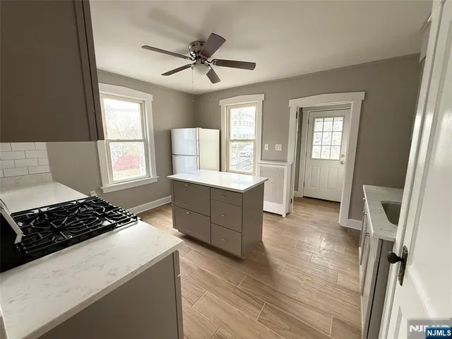 a kitchen with a stove a sink and a refrigerator