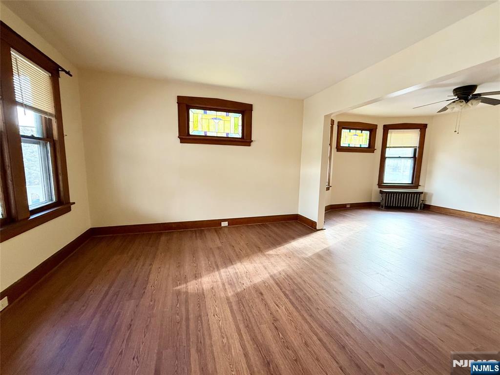 140 Westervelt Avenue, Unit 1 Hawthorne, NJ 07506 - Photo 9 of 20 a view of an empty room with wooden floor and a window