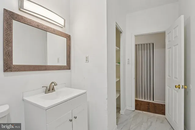 a bathroom with a sink vanity and a mirror