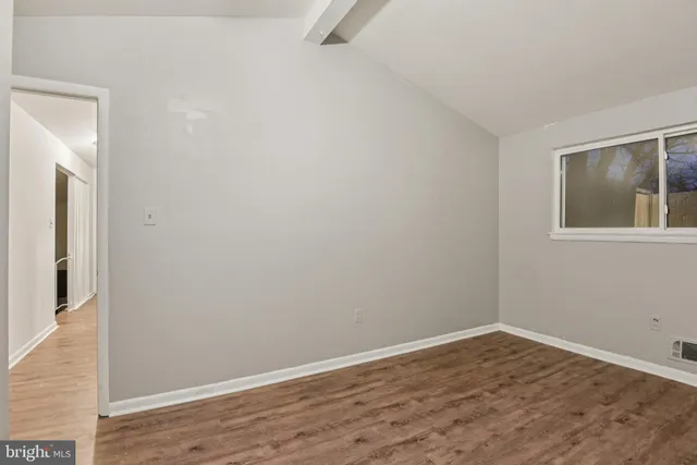 a view of a room that has wooden floor and cabinet
