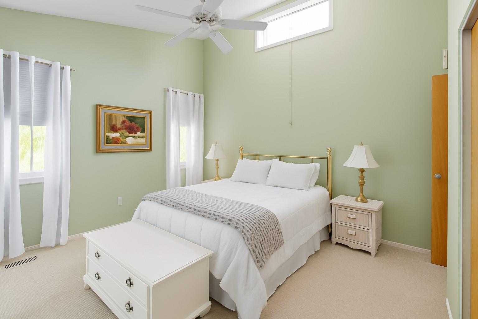 60 Quogue Riverhead Road Quogue, NY 11959 - Photo 15 of 20 a bedroom with a bed and a painting on the wall