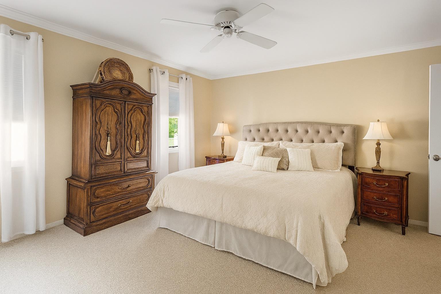 60 Quogue Riverhead Road Quogue, NY 11959 - Photo 8 of 20 a bedroom with a bed and a dresser