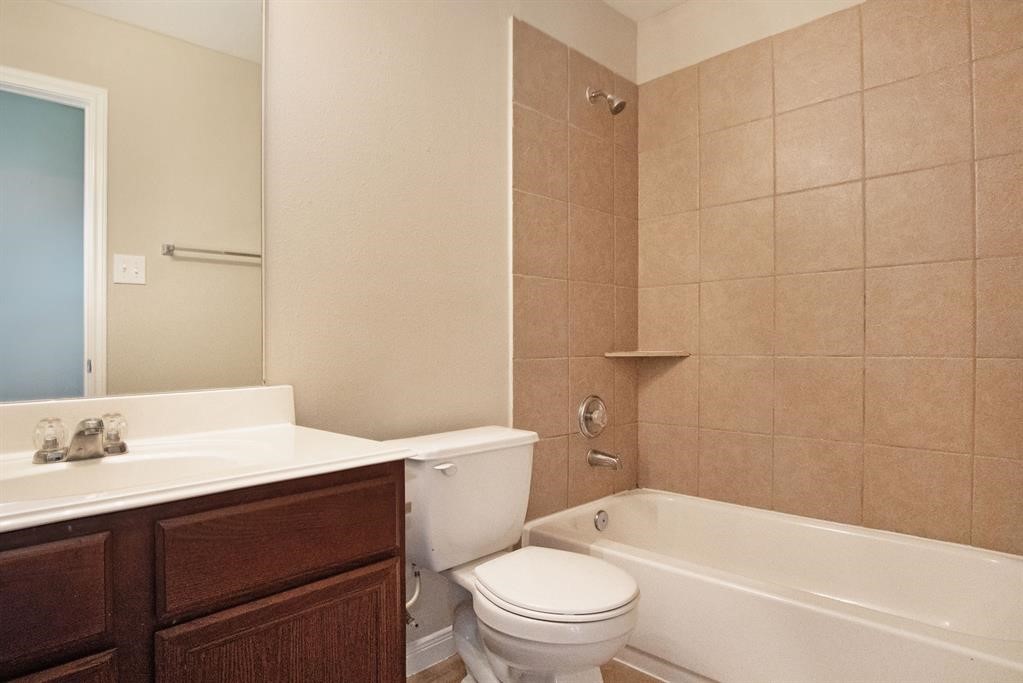 127 Rodeo Drive Manvel, TX 77578 - Photo 14 of 14 a bathroom with a sink a toilet and shower
