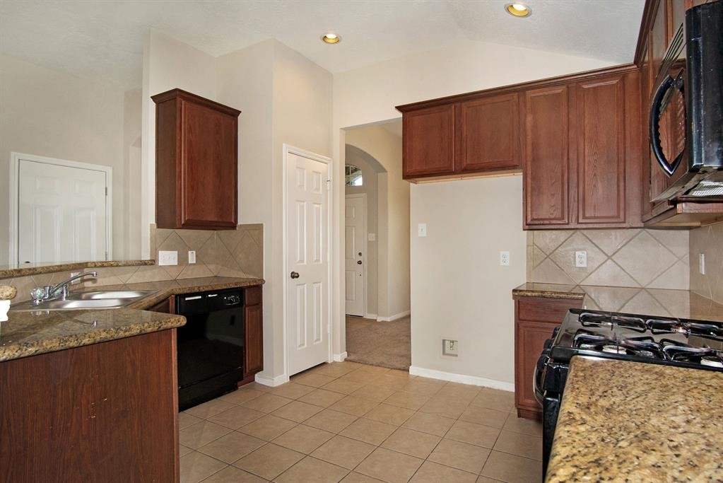 127 Rodeo Drive Manvel, TX 77578 - Photo 2 of 14 a kitchen with a sink stove and refrigerator