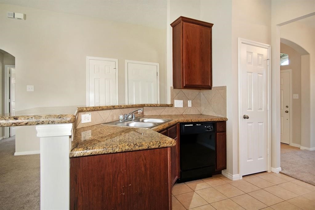 127 Rodeo Drive Manvel, TX 77578 - Photo 7 of 14 a bathroom with a granite countertop sink and a mirror