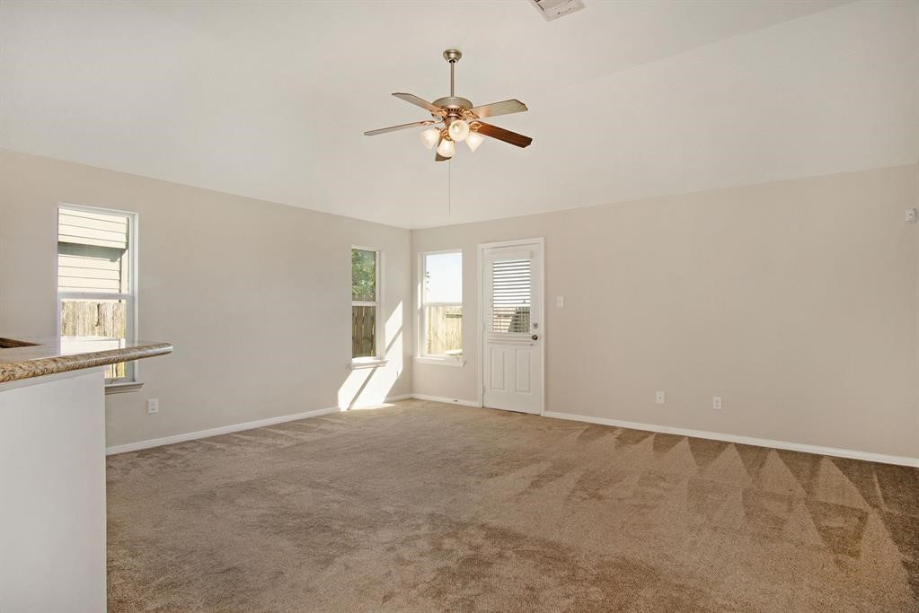 127 Rodeo Drive Manvel, TX 77578 - Photo 9 of 14 a view of a livingroom with a ceiling fan and window