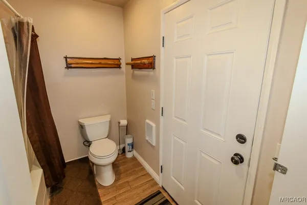 a bathroom with a toilet and a shower