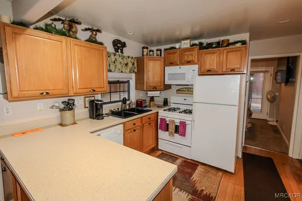 a kitchen with stainless steel appliances a stove a refrigerator and cabinets