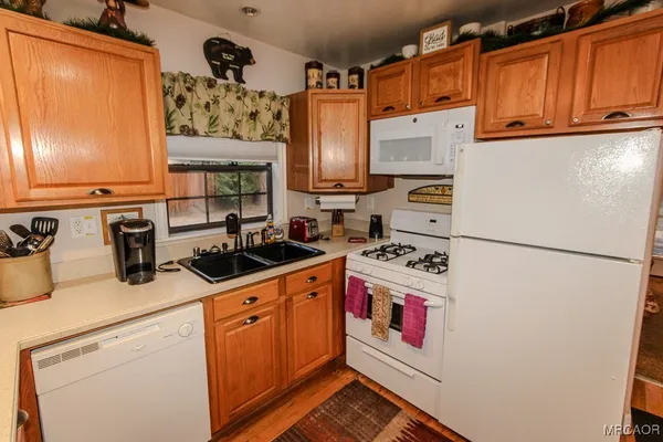 a kitchen with stainless steel appliances sink and cabinets