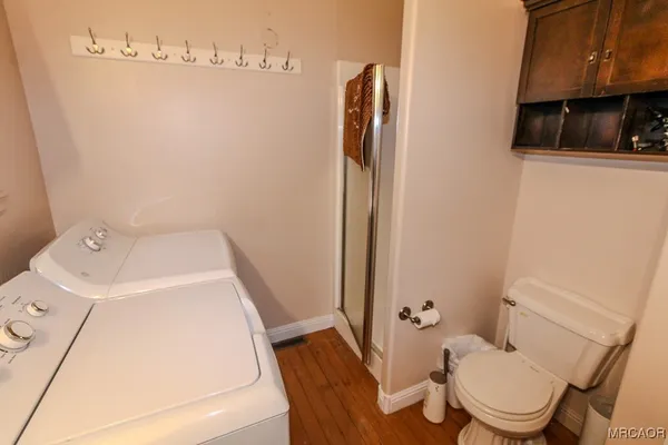 a white toilet sitting next to a bathroom sink