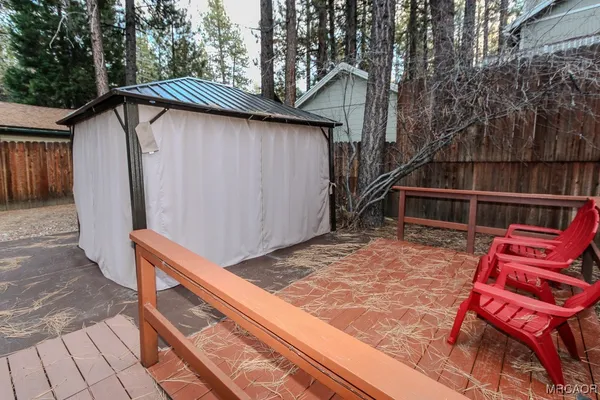 a view of a backyard with a deck and wooden floor