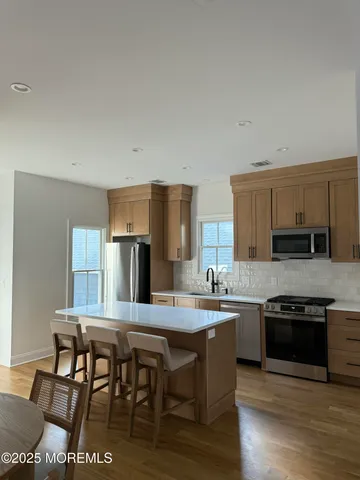 a kitchen with stainless steel appliances granite countertop a stove top oven a sink and dishwasher