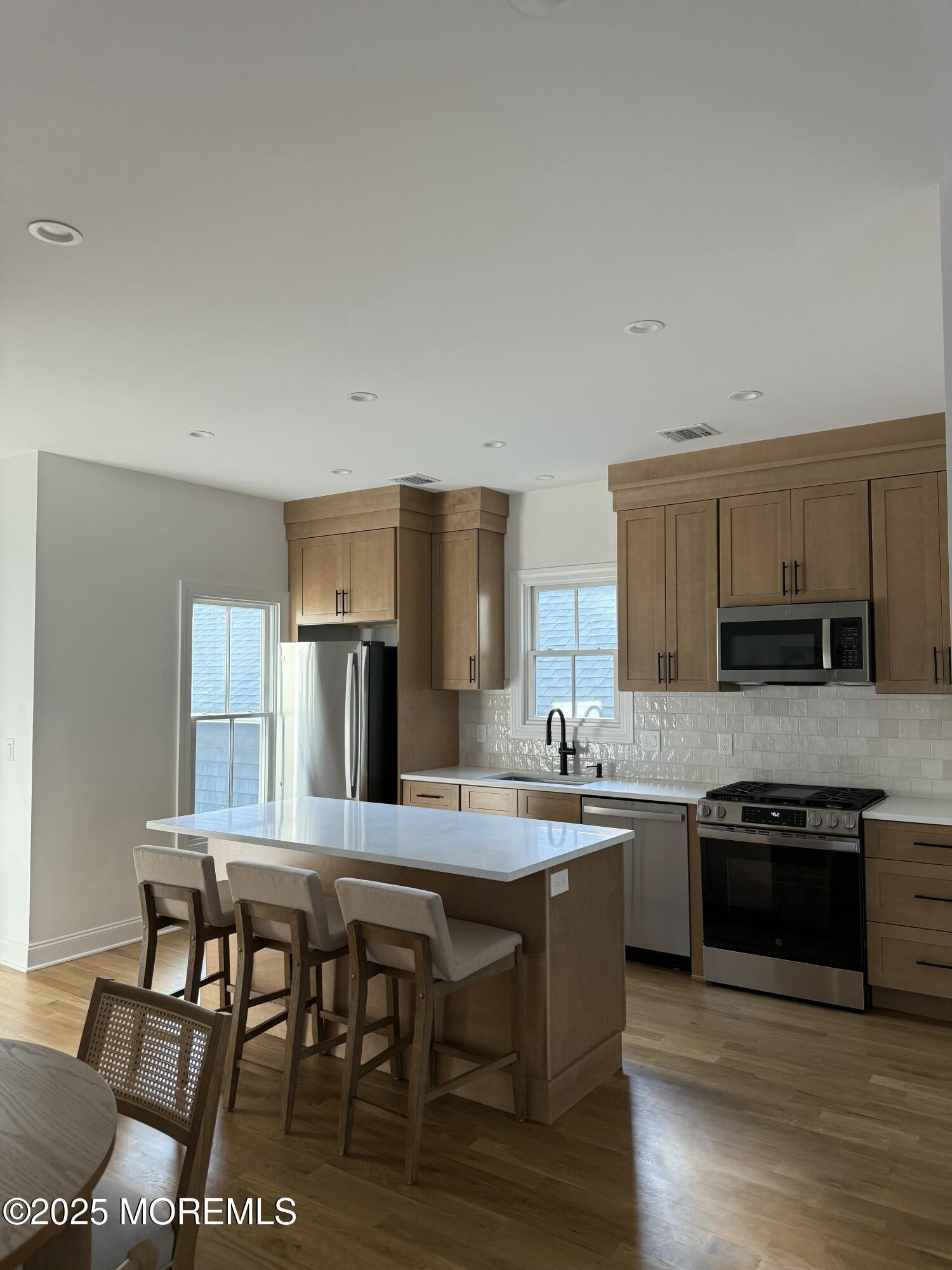 a kitchen with stainless steel appliances granite countertop a stove top oven a sink and dishwasher