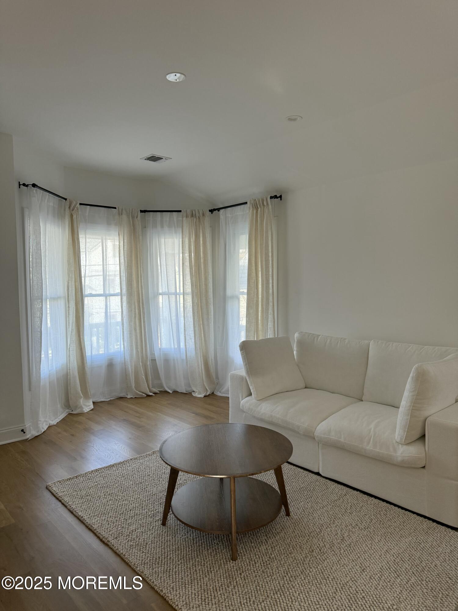 22 Atlantic Avenue Ocean Grove, NJ 07756 - Photo 2 of 8 a living room with furniture and a large window