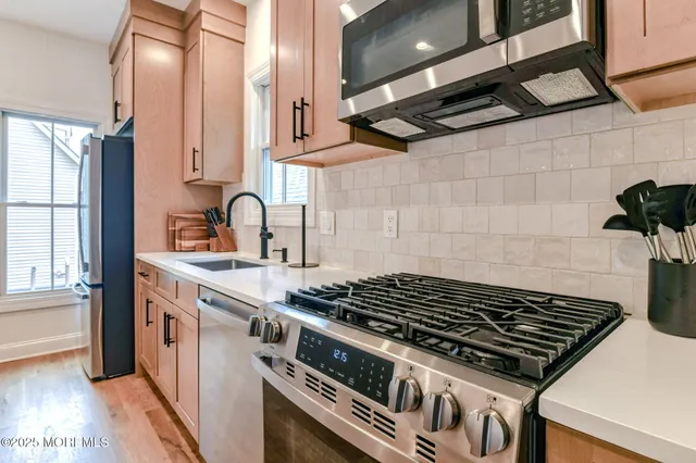 a stove top oven sitting inside of a kitchen