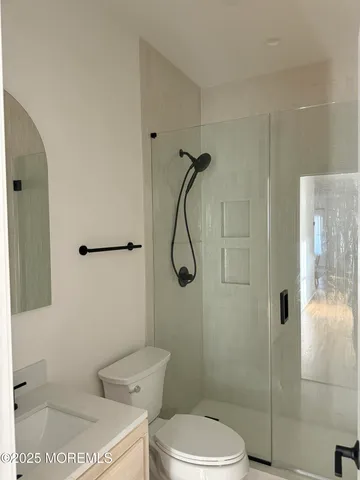 a bathroom with a toilet and shower