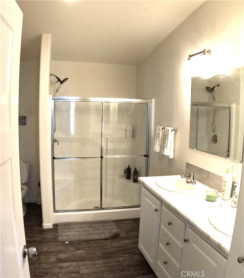 21621 Sandia Road, Unit 130 Apple Valley, CA 92308 - Photo 18 of 45 a bathroom with a double vanity sink mirror and shower