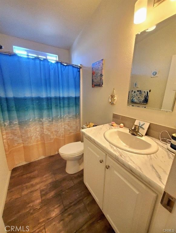21621 Sandia Road, Unit 130 Apple Valley, CA 92308 - Photo 25 of 45 a bathroom with a sink toilet and a mirror