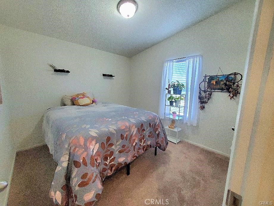 21621 Sandia Road, Unit 130 Apple Valley, CA 92308 - Photo 27 of 45 a bedroom with a bed and a window
