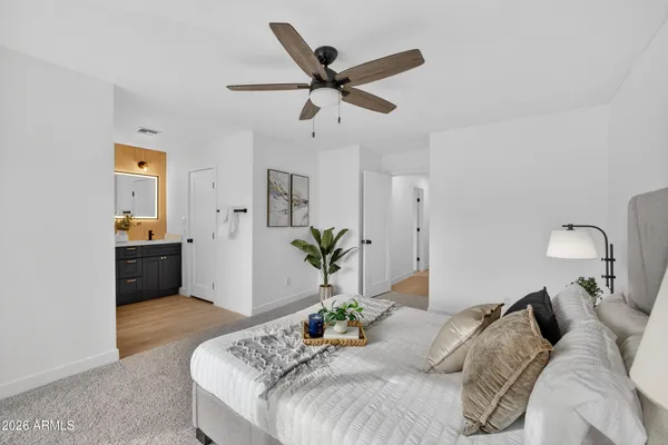 a bedroom with a bed and ceiling fan