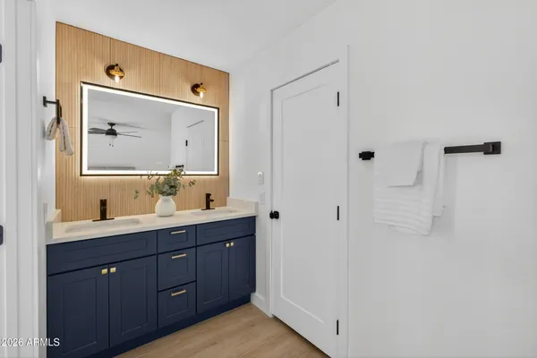 a bathroom with a double vanity sink mirror and
