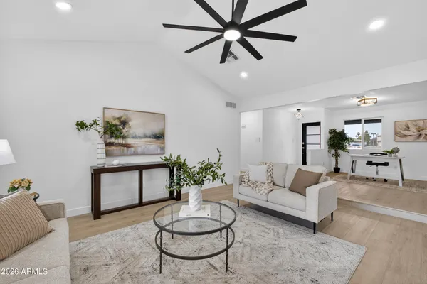 a living room with furniture and kitchen view