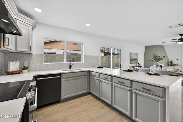 a kitchen with a sink stove and cabinets