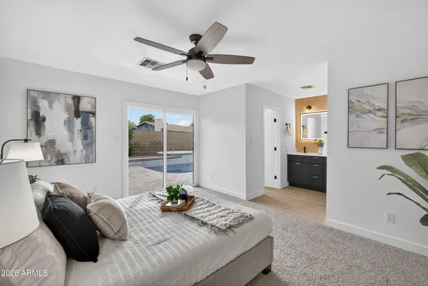 a bedroom with a bed and a large window