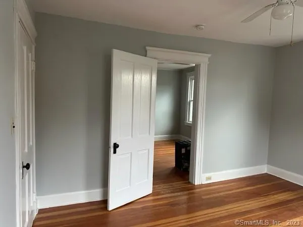 an empty room with wooden floor and closet