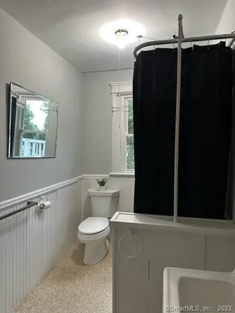 a bathroom with a toilet and a shower
