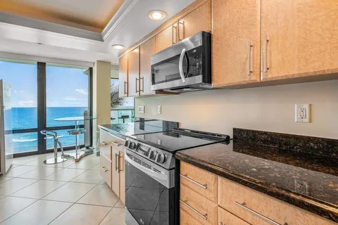 a kitchen with stainless steel appliances granite countertop a sink and a stove
