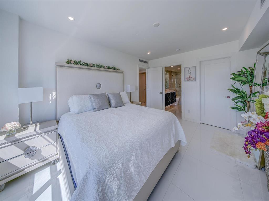 2500 East Las Olas Boulevard, Unit 707 Fort Lauderdale, FL 33301 - Photo 11 of 29 a bedroom with a bed and a potted plant